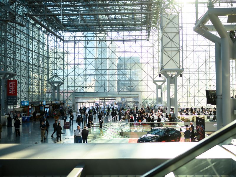 Image of NAB Show New York taking place inside the Javits Convention Center, capturing the windows and light shining through onto the Show floor.
